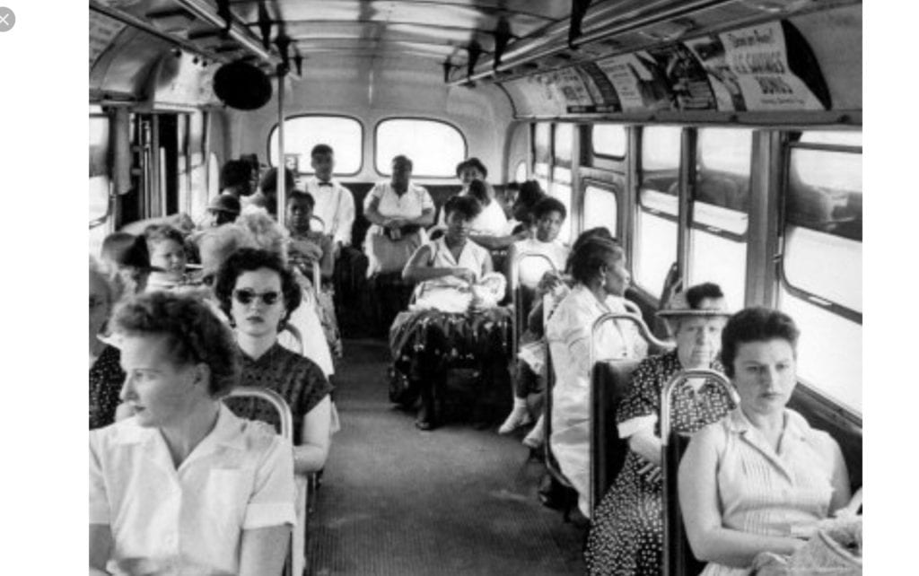 Passengers seated inside a vintage city bus.